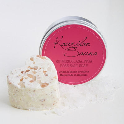 Kaurilan saunan 120 gramman ruususuolasaippua ja sen kierrekorkillinen metallipurkki, jossa on pinkki etiketti.